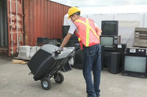 Experienced clearance workers handling bulky furniture